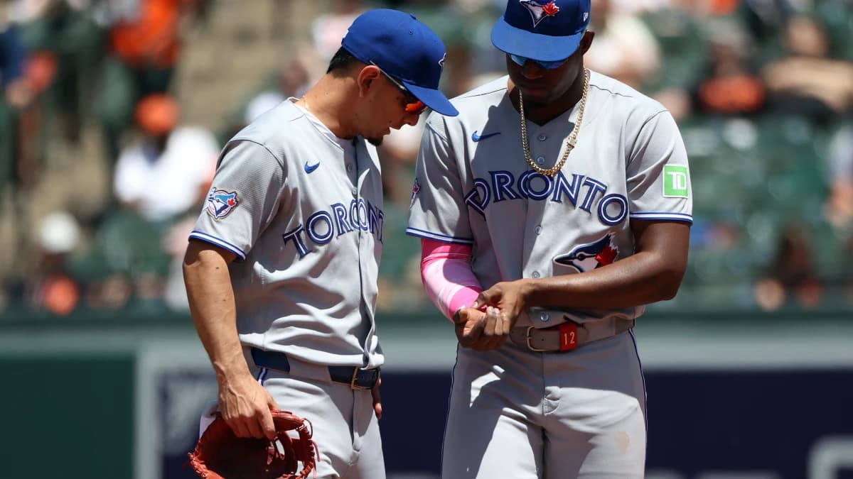 Toronto Blue Jays right fielder Jesus Sanchez (12) speaks to Toronto Blue Jays shortstop Andres Gimenez (0) during the sixth inning against the Baltimore Orioles at Oriole Park at Camden Yards.