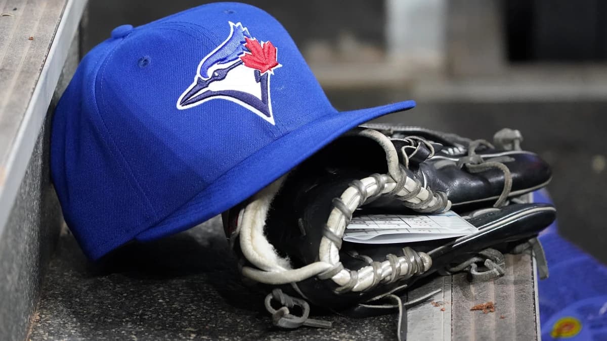 A Toronto Blue Jays hat and glove in the dugout during a game against the Atlanta Braves at Rogers Centre.
