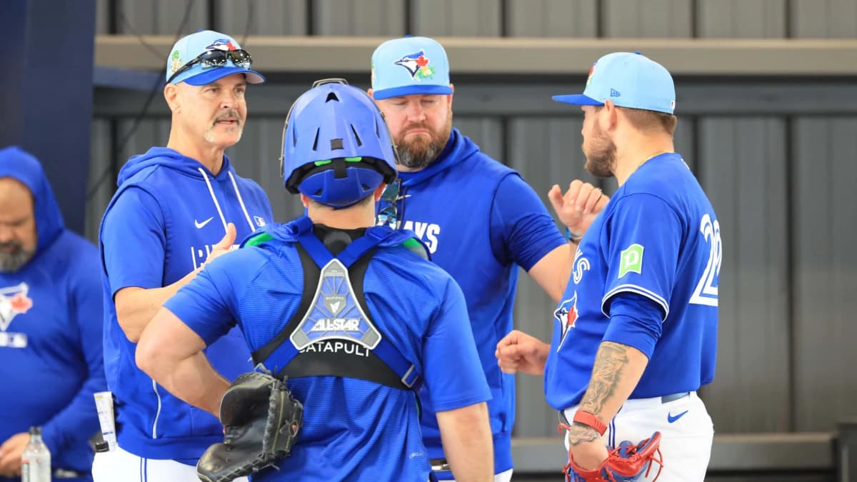 Toronto Blue Jays pitcher Yariel Rodriguez (29) talks with catcher Alejandro Kirk (30), pitching coach Pete Walker (41) and manager John Schneider (14) after he throws a bullpen session for spring training practice at Blue Jays Player Development Complex.