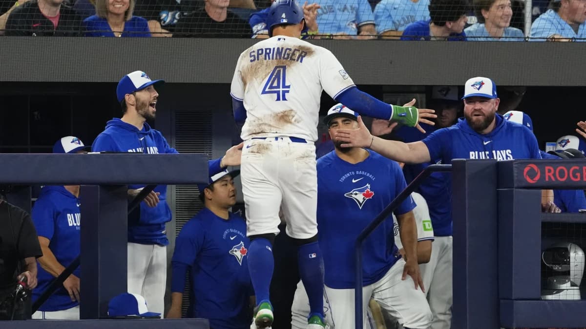 Toronto Blue Jays designated hitter George Springer (4) celebrates scoring against the Philadelphia Phillies during the seventh inning at Rogers Centre.