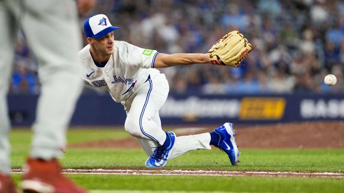Toronto Blue Jays pitcher Tyler Rogers (71) makes a glove pass to first base against the Philadelphia Phillies during the eighth inning at Rogers Centre.