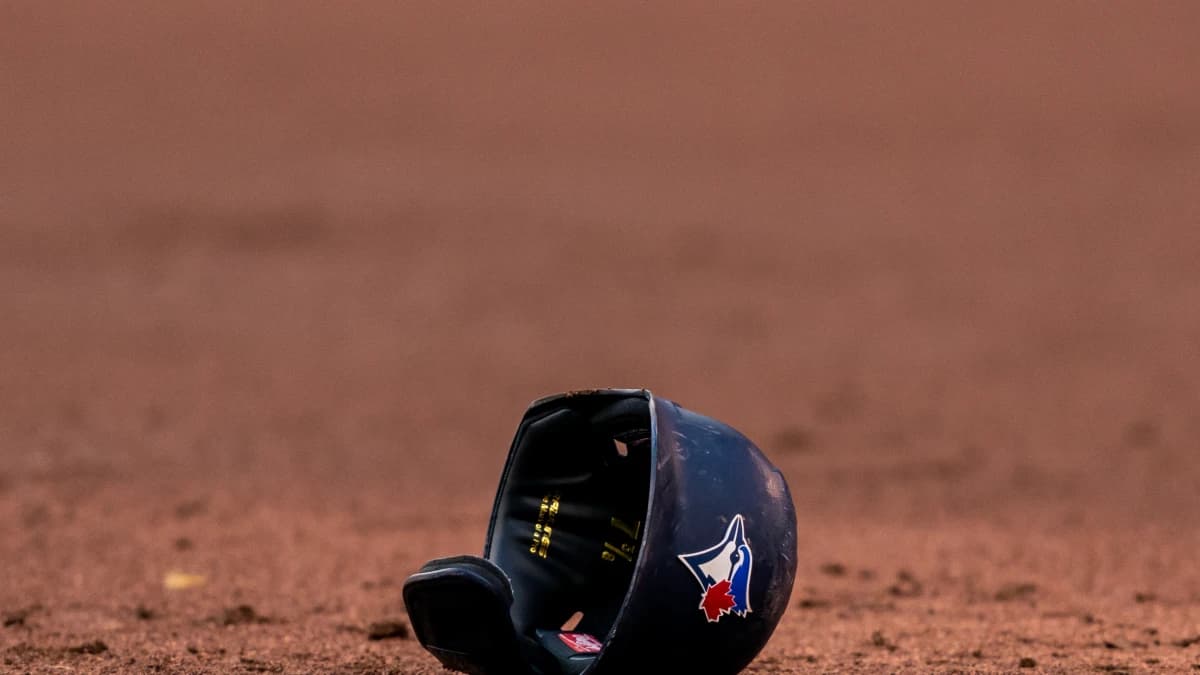 Toronto Blue Jays helmet lays on the infield at an MLB game against the Cleveland Indians at Rogers Centre.