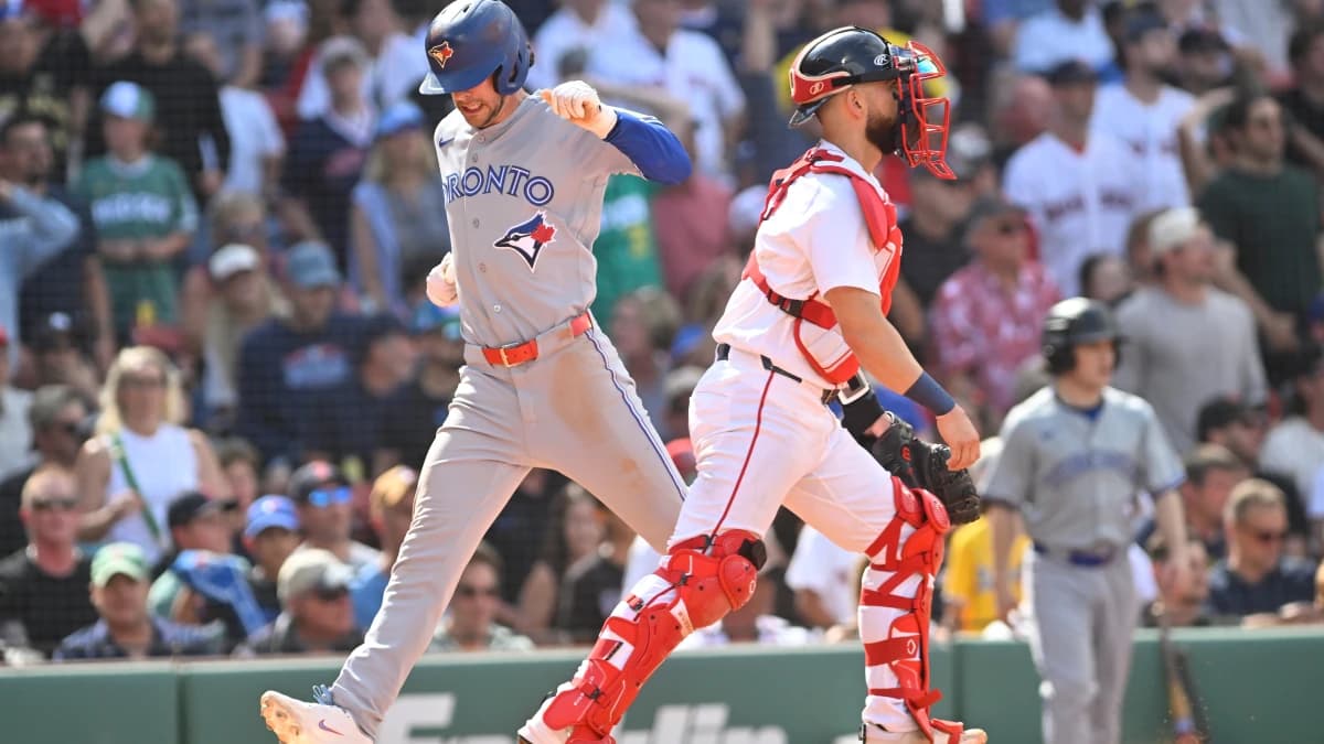 Toronto Blue Jays second baseman Ernie Clement (22) scores a run against the Boston Red Sox during the ninth inning at Fenway Park.