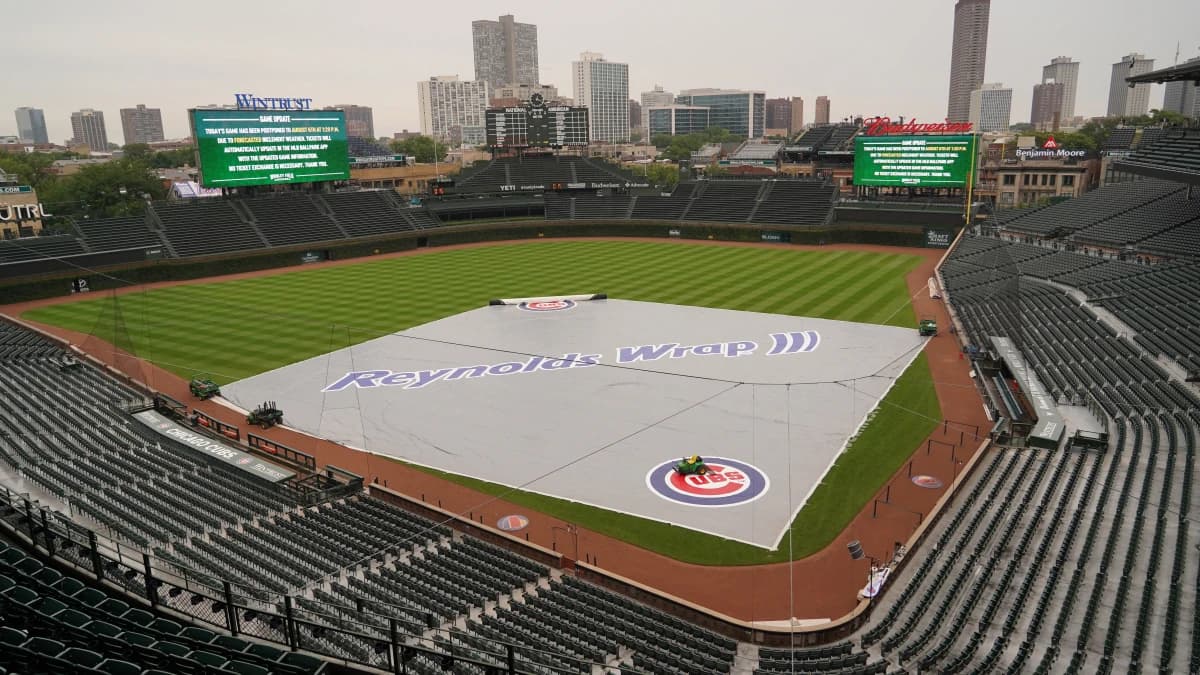 The Tarp is seen on the field as a game between the Chicago Cubs and the Toronto Blue Jays has been postponed due to weather at Wrigley Field.