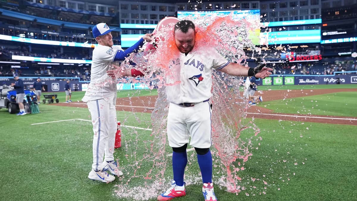 Toronto Blue Jays catcher Alejandro Kirk (30) has the water bucket poured on him against the Houston Astros at the end of the ninth inning at Rogers Centre.