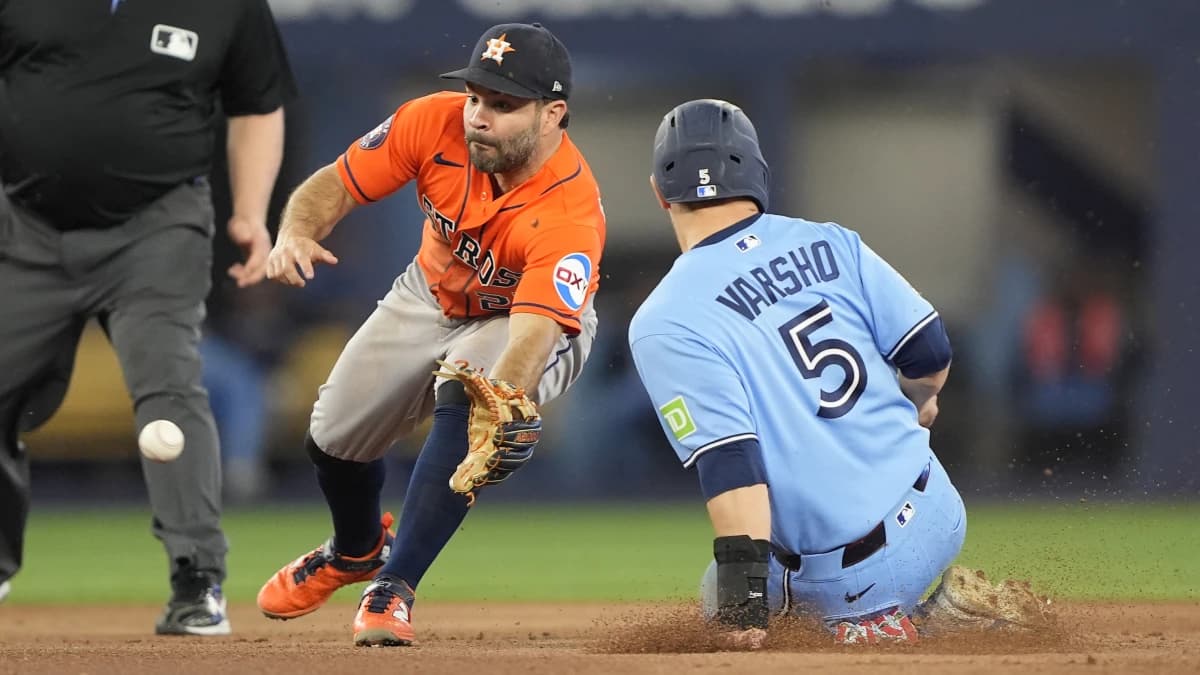 Toronto Blue Jays center fielder Daulton Varsho (5) steals second base against Houston Astros second baseman Jose Altuve (27) during the seventh inning at Rogers Centre.