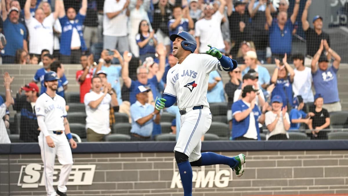 Toronto Blue Jays designated hitter George Springer (4) reacts after scoring a run on a triple and an error against the New York Mets in the first inning at Rogers Centre.
