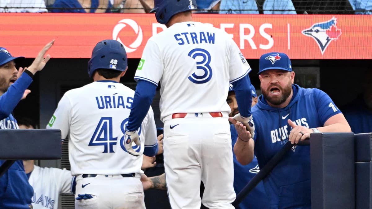 Toronto Blue Jays center fielder Myles Straw (3) is greeted by manager John Schneider (14) after his sacrifice fly scored second baseman Luis Urias (48) against the New York Mets in the fifth inning at Rogers Centre.