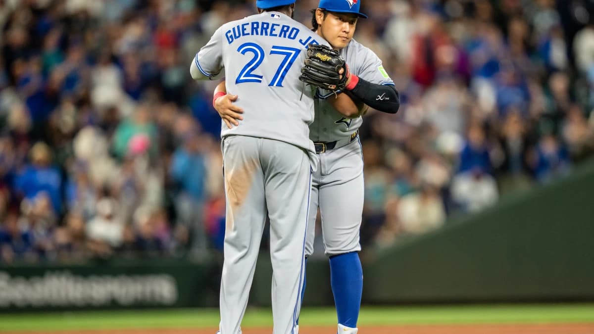 Toronto Blue Jays first baseman Vladimir Guerrero Jr. (27) and third baseman Kazuma Okamoto (7) celebrate after a game against the Seattle Mariners at T-Mobile Park