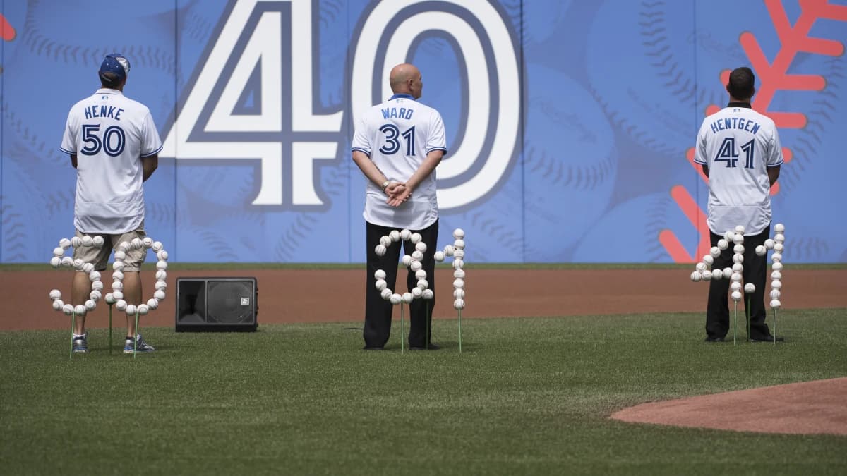 Former Toronto Blue Jays pitchers Tom Henke and Duane Ward and Pat Heineken watch the giant screen during the 40th Season Ceremonies prior to a game against the Houston Astros at Rogers Centre. The Toronto Blue Jays won 9-2