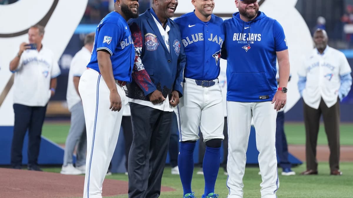 Toronto Blue Jays first baseman Vladimir Guerrero Jr. (27) and designated hitter George Springer (4) and manager John Schneider (14) and former player Joe Carter pose for a photo before a game against the Chicago White Sox at Rogers Centre.