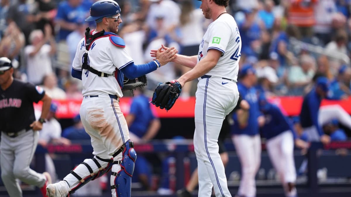 Toronto Blue Jays catcher Danny Jansen (9) celebrates the win with relief pitcher Nate Pearson (24) at the end of the ninth inning after a game against the Cleveland Guardians at Rogers Centre.