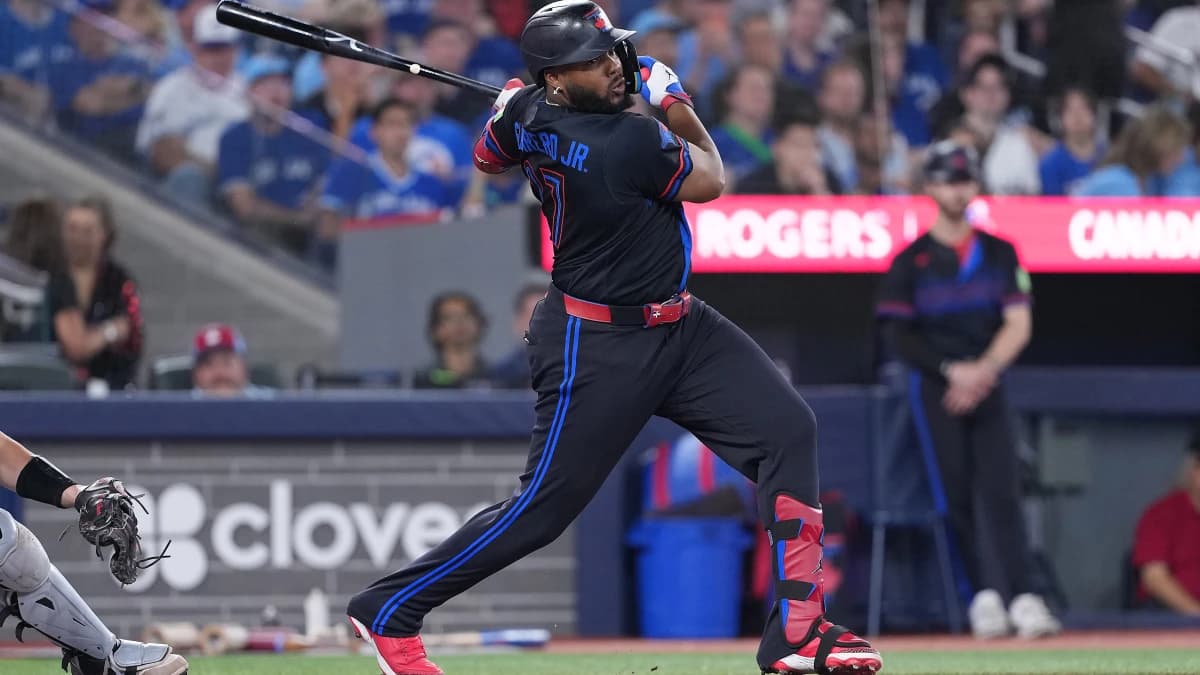 Toronto Blue Jays first baseman Vladimir Guerrero Jr. (27) hits a single against the Chicago White Sox during the third inning at Rogers Centre.