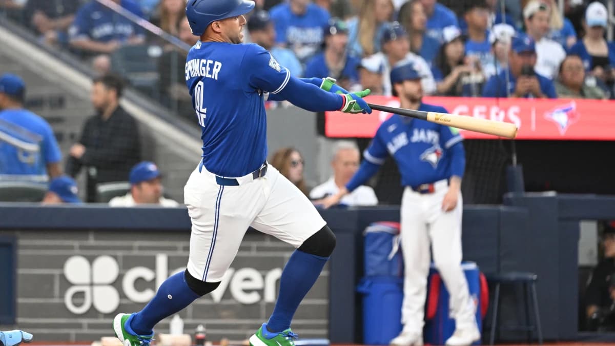 Toronto Blue Jays designated hitter George Springer (4) hits a single against the Tampa Bay Rays in the third inning at Rogers Centre.