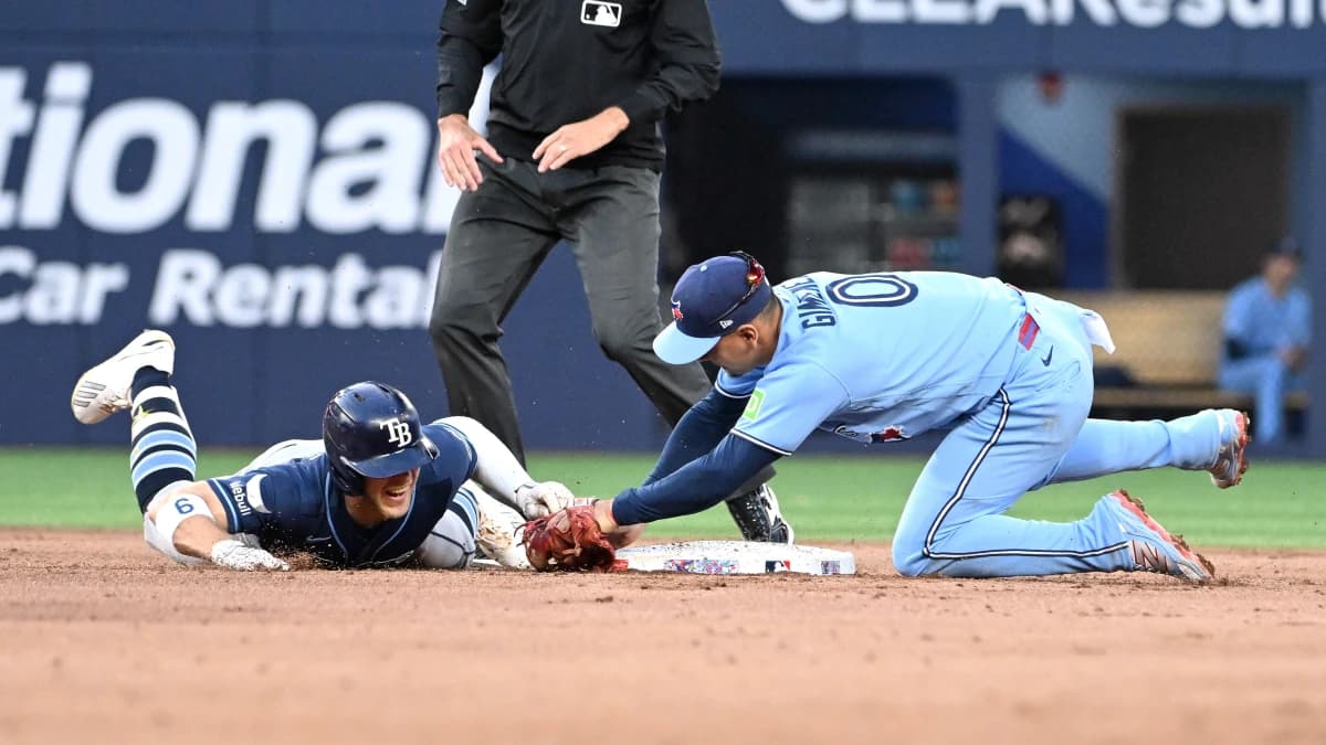 Toronto Blue Jays shortstop Andres Gimenez (0) tags out Tampa Bay Rays shortstop Taylor Walls (5) after Walls tried to stretch a double in the fifth inning at Rogers Centre.