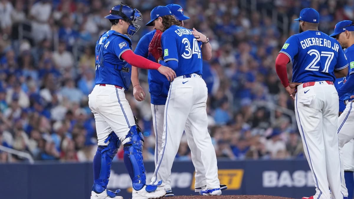 Toronto Blue Jays pitcher Kevin Gausman (34) is relieved by manager John Schneider (14) against the Tampa Bay Rays during the fourth inning at Rogers Centre