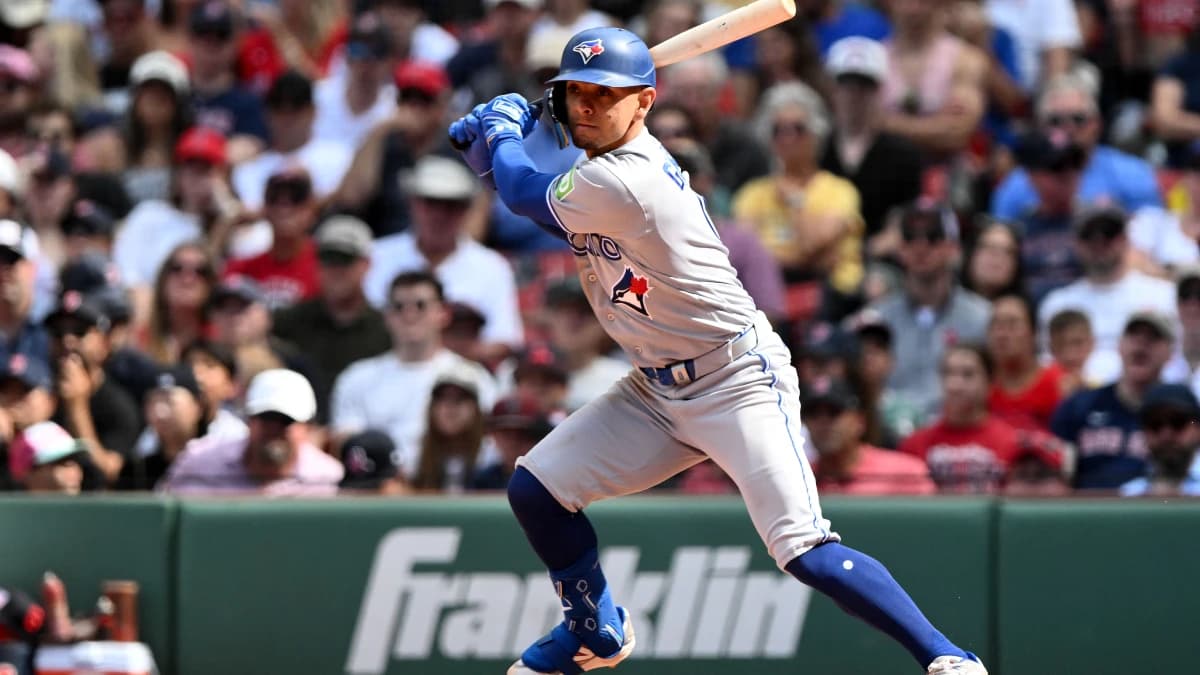 Toronto Blue Jays shortstop Andrés Giménez (0) hits a RBI single against the Boston Red Sox during the ninth inning at Fenway Park.