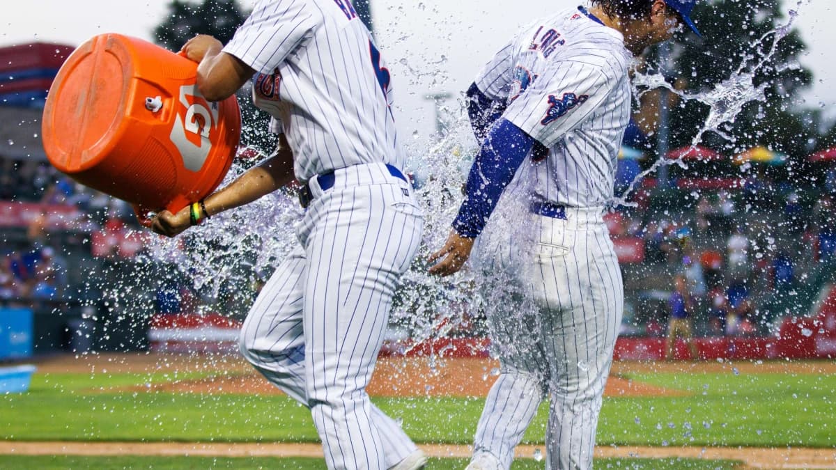 South Bend Cubs outfielder Brett Bateman, left, throws water on infielder Jonathon Long after winning a minor league baseball 4-3 against the Lake County Captains game at Four Winds Field on Friday, June 21, 2024, in South Bend.