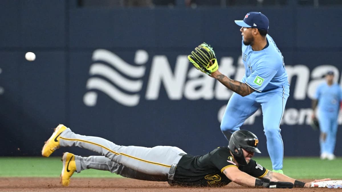 Pittsburgh Pirates first baseman Spencer Horwitz (2) dives back to second base as Toronto Blue Jays second baseman Lenyn Sosa (50) waits for the throw in the second inning at Rogers Centre.