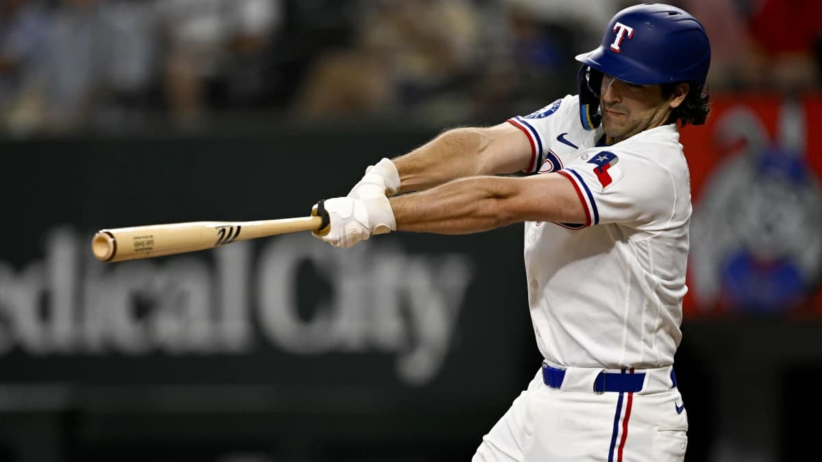 Texas Rangers second baseman Josh Smith (8) hits a single against the Los Angeles Angels during the third inning at Globe Life Field.