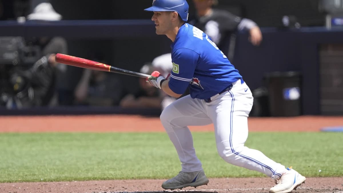 Toronto Blue Jays center fielder Daulton Varsho (5) singles against the Chicago White Sox during the seventh inning at Rogers Centre.