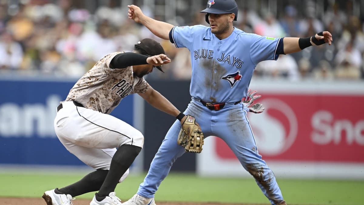 Toronto Blue Jays center fielder Daulton Varsho (5) steals second base ahead of the tag of San Diego Padres shortstop Xander Bogaerts (2) during the fifth inning at Petco Park.