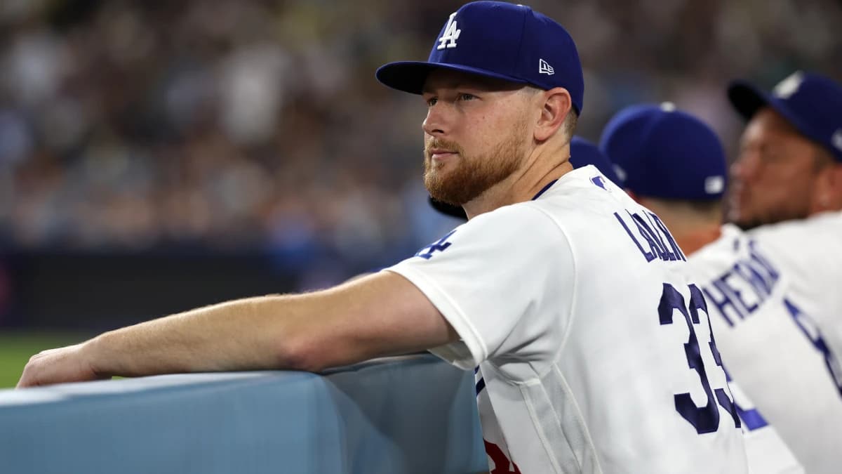 Los Angeles Dodgers pitcher Eric Lauer (33) watches a game from the dugout during the seventh inning against the Seattle Mariners at Dodger Stadium