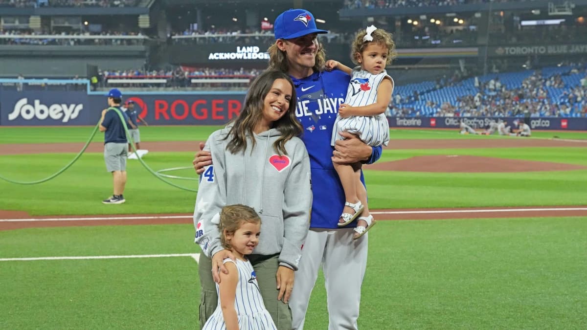 Toronto Blue Jays starting pitcher Kevin Gausman (34) poses for a photo with his family prior to start of a game against the San Francisco Giants at Rogers Centre.