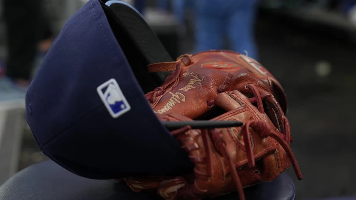 The hat and glove of Toronto Blue Jays shortstop Andres Gimenez (0) in the dug out during an at bat against the Houston Astros at Rogers Centre.