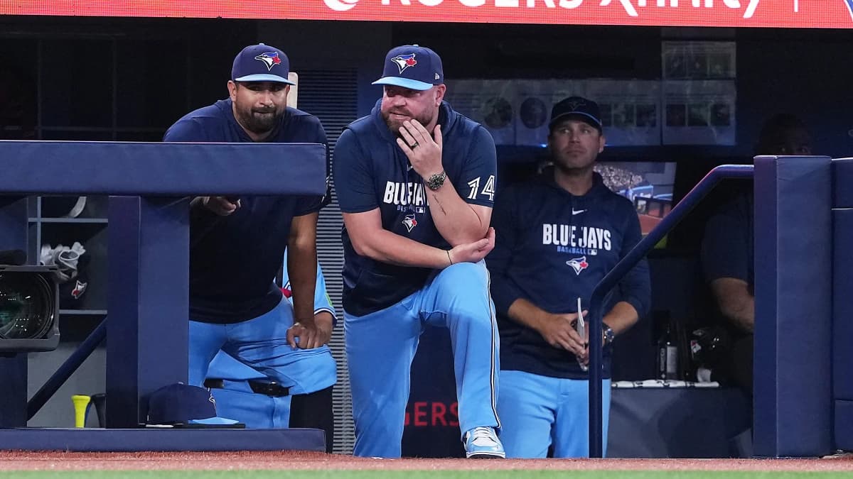 Toronto Blue Jays manager John Schneider (14) watches the play from the dugout against the St. Louis Cardinals during the eighth inning at Rogers Centre.