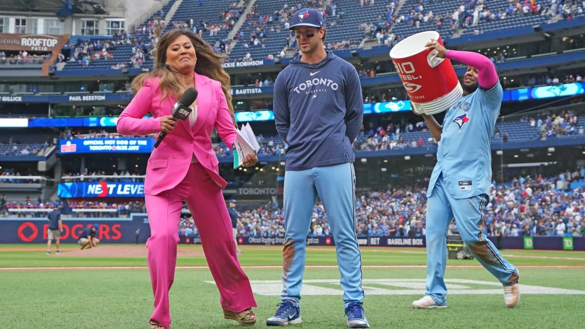 Sportsnet sportscaster Hazel Mae avoids the water bucket by Toronto Blue Jays first baseman Vladimir Guerrero Jr. (27) on shortstop Ernie Clement (28) against the Washington Nationals at the end of the ninth inning at Rogers Centre.