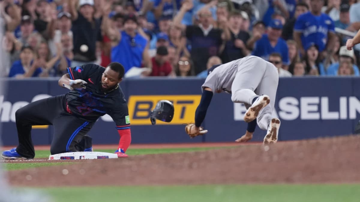 Toronto Blue Jays first baseman Vladimir Guerrero Jr. runs into New York Yankees shortstop George Lombard Jr. (96) during the sixth inning at Rogers Centre.