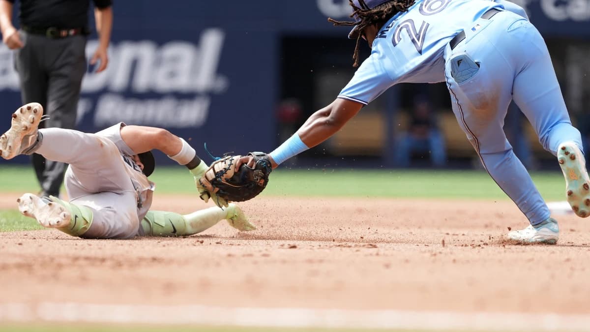 New York Yankees second baseman Jose Caballero (72) is tagged out by Toronto Blue Jays first baseman Charles McAdoo (26) during the seventh inning at Rogers Centre