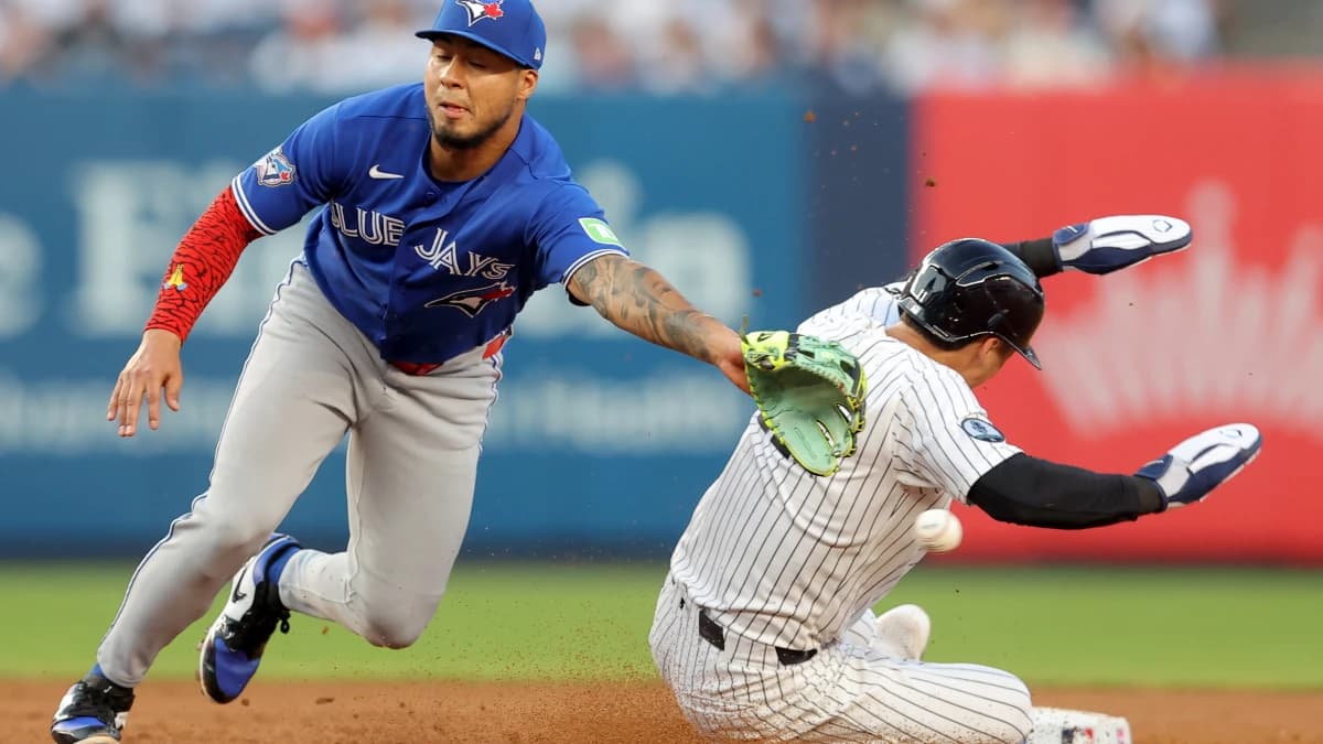 New York Yankees shortstop Anthony Volpe (11) steals second base as the throw goes by Toronto Blue Jays second baseman Lenyn Sosa (50) allowing him to advance to third base during the second inning at Yankee Stadium.