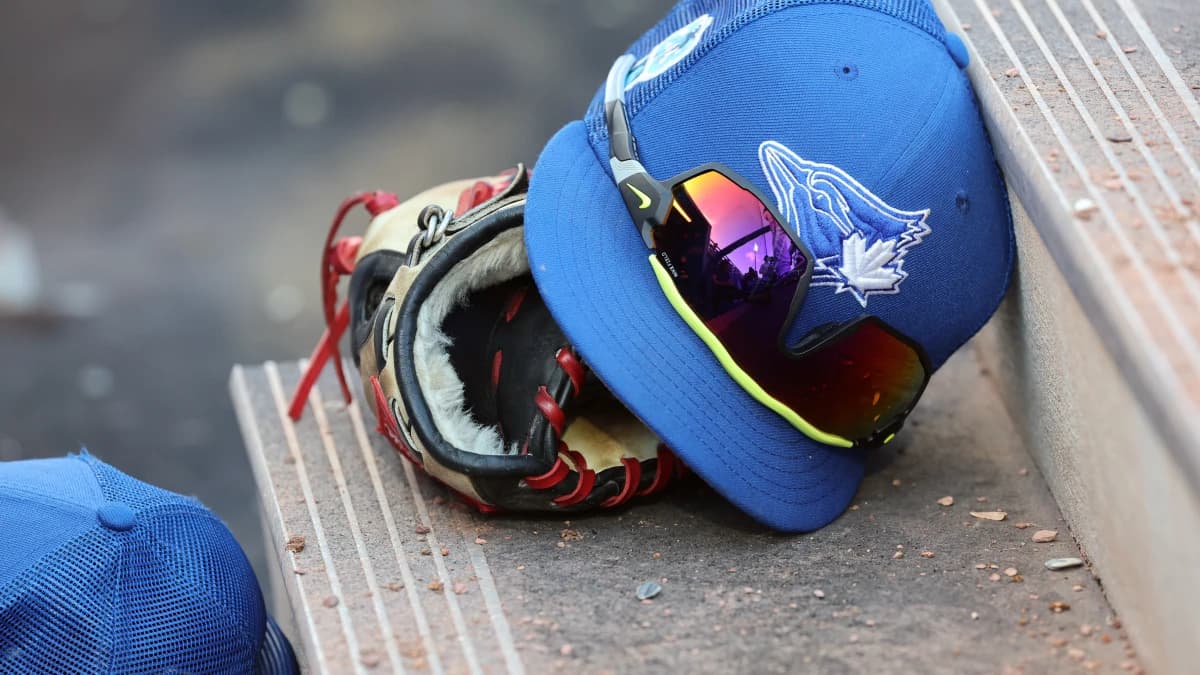 A detail view of Toronto Blue Jays hat and glove against the Detroit Tigers at TD Ballpark