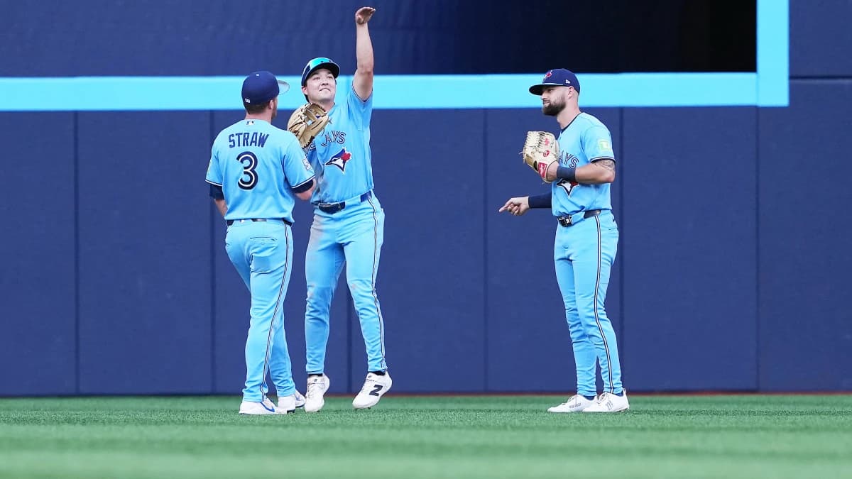 Toronto Blue Jays left fielder Myles Straw (3) and center fielder Brett Bateman (21) and right fielder Nathan Lukes (38) celebrate the win gainst the New York Yankees at the end of the ninth inning at Rogers Centre.