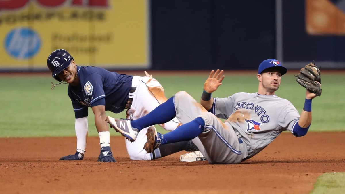 Tampa Bay Rays center fielder Mallex Smith (0) slides into second base as Toronto Blue Jays second baseman Jon Berti (64) attempts to tag him out at Tropicana Field.