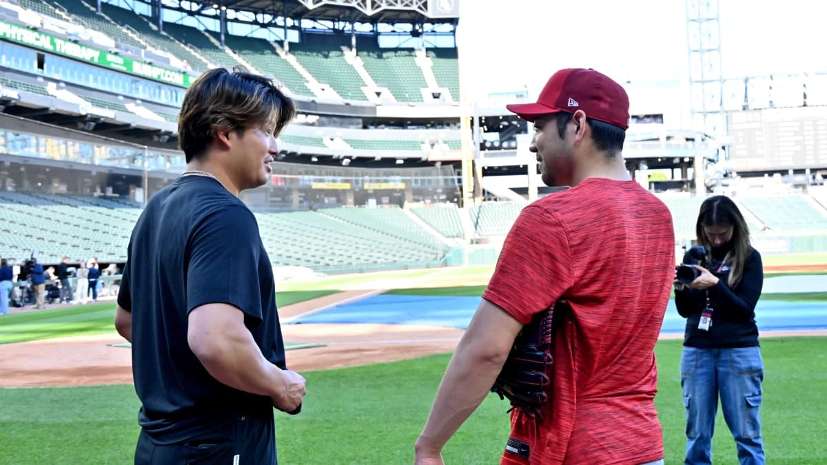 Chicago White Sox first baseman Munetaka Murakami (5) and Los Angeles Angels pitcher Yusei Kikuchi (16) talk to each other prior to a game at Rate Field