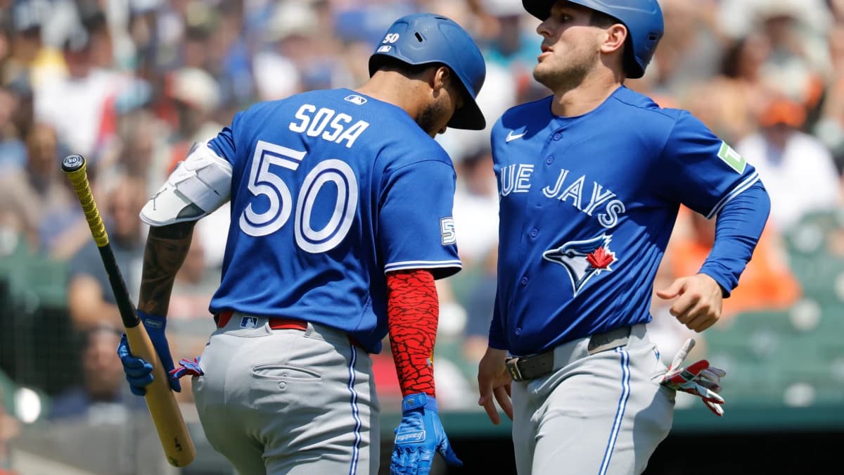 Toronto Blue Jays center fielder Daulton Varsho (5) receives congratulations from Toronto Blue Jays second baseman Lenyn Sosa (50) after scoring in the first inning against the Detroit Tigers at Comerica Park.