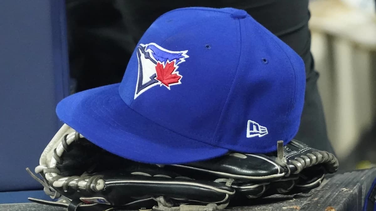 A Toronto Blue Jays hat and glove in the dugout during the third inning against the Los Angeles Dodgers at Rogers Centre