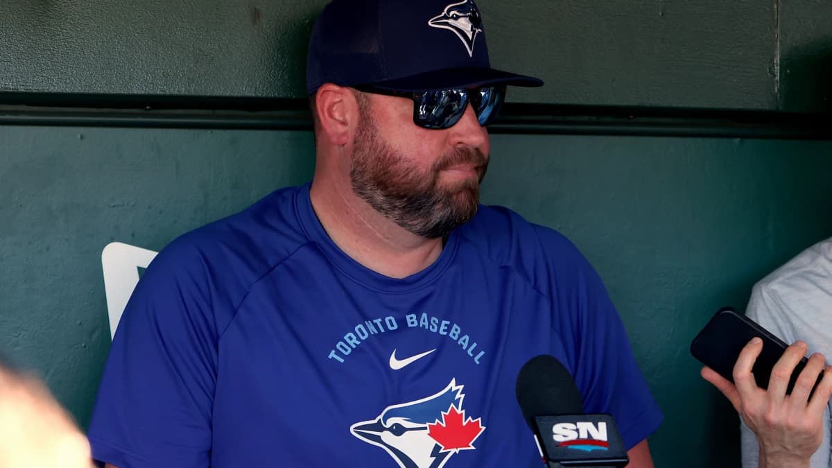 Toronto Blue Jays manager John Schneider (14) speaks to the media in the dugout before a game against the Athletics at Sutter Health Park.