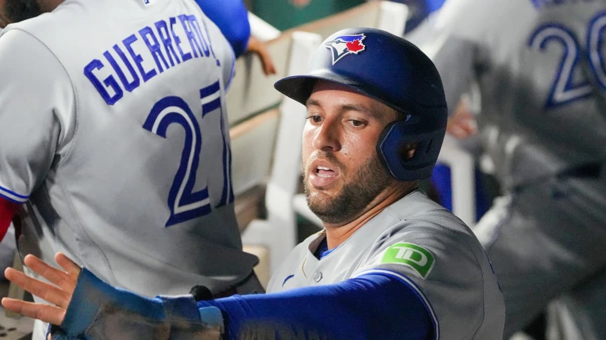 Toronto Blue Jays designated hitter George Springer (4) celebrates in the dugout after scoring against the Kansas City Royals during the seventh inning at Kauffman Stadium.