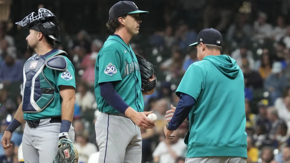 Seattle Mariners pitcher Logan Gilbert (36) is taken out of the game by Seattle Mariners manager Dan Wilson (6) in the sixth inning against the Milwaukee Brewers at American Family Field.