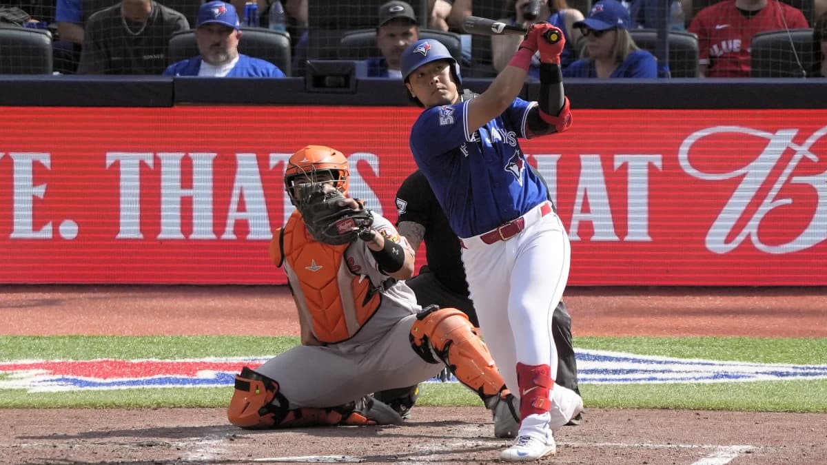 Toronto Blue Jays third baseman Kazuma Okamoto (7) hits a solo home run against the Baltimore Orioles during the fifth inning at Rogers Centre.
