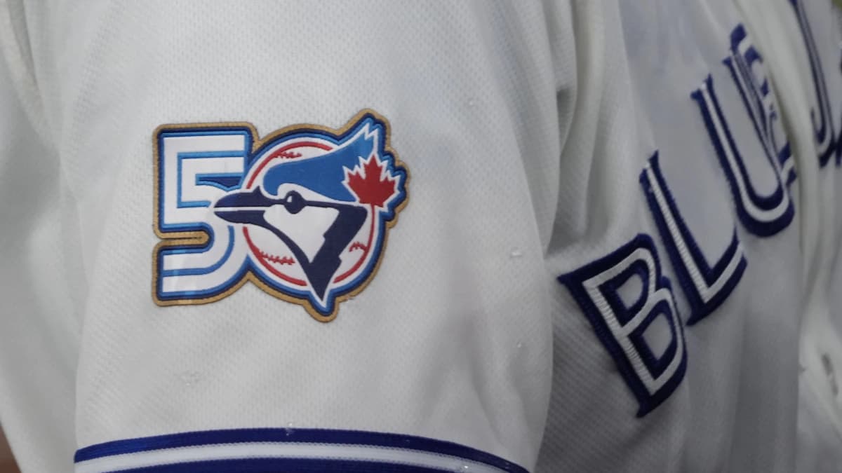The Toronto Blue Jays 50th anniversary logo displayed on the jersey of third baseman Kazuma Okamoto (7) duringa game against the Athletics at Rogers Centre.
