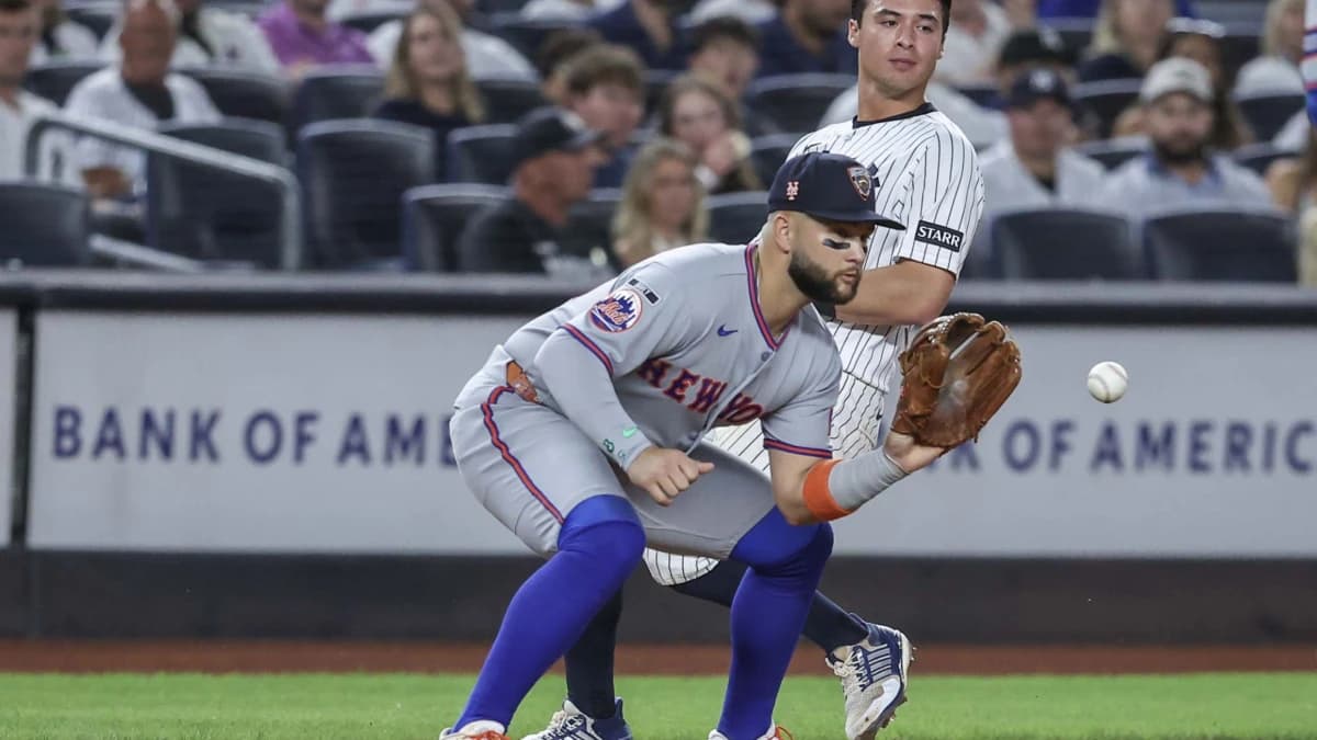 New York Yankees second baseman Anthony Volpe (11) beats the throw to New York Mets third baseman Bo Bichette (19) in the second inning at Yankee Stadium.