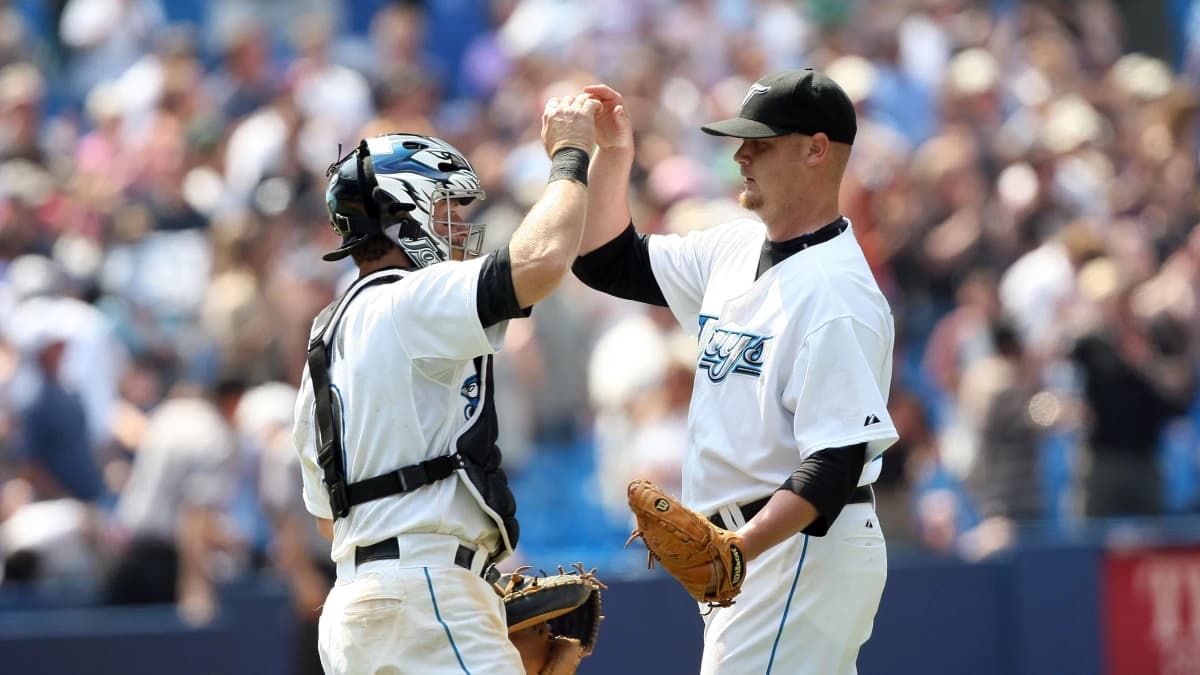 Toronto Blue Jays pitcher (40) Brian Wolfe is congratulated by catcher (9) Gregg Zaun after defeating the Minnesota Twins 13-1 at the Rogers Centre in Toronto, ON. Toronto won 13-1