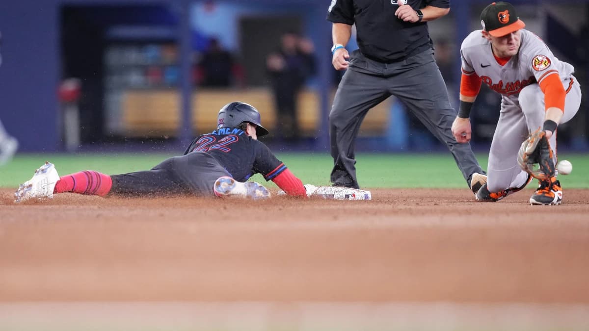 Toronto Blue Jays second baseman Ernie Clement (22) slides into second base with a double ahead of the tag from Baltimore Orioles shortstop Gunnar Henderson (2) during the ninth inning at Rogers Centre.