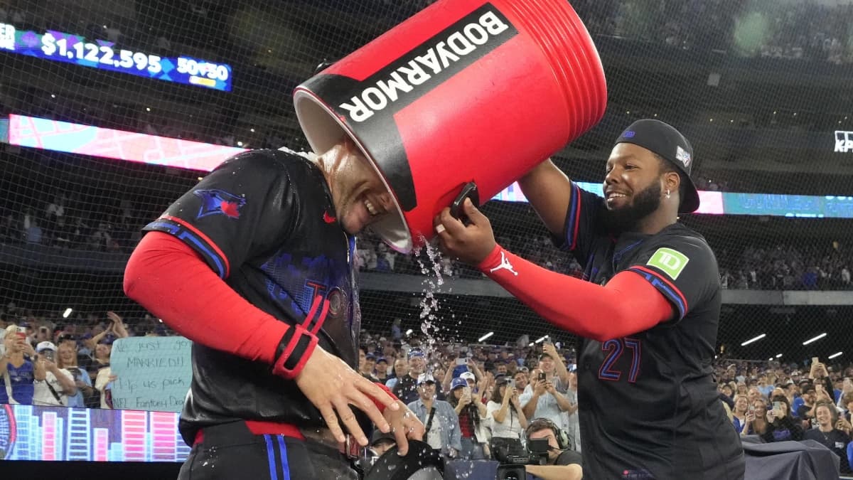 Toronto Blue Jays first baseman Vladimir Guerrero Jr. (27) puts an empty bucket of ice water over top of designated hitter George Springer (4) after a win over the Seattle Mariners at Rogers Centre