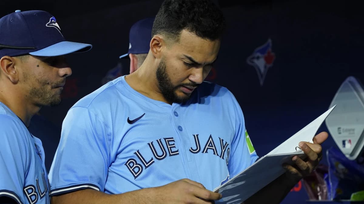 Toronto Blue Jays designated hitter Anthony Santander (25) and second baseman Andres Gimenez (0) review a playbook before a game against the Cleveland Guardians at Rogers Centre.